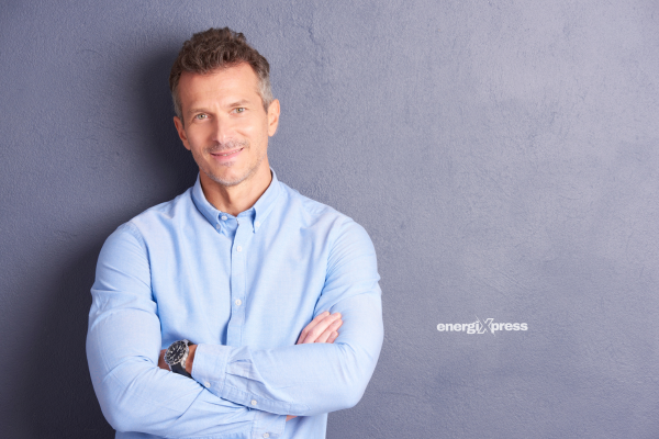 A confident man, standing tall, with a healthy appearance and lots of energy